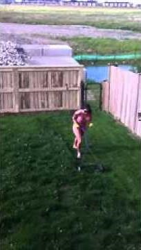 My wife attempting to mow the lawn in her bikini