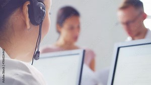 Diverse team of young professionals is working in the phone support office. Working day of sales managers in the call center. Business, telephone consulting and problem solving.