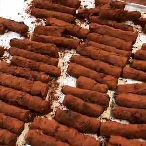 Prosecco and pecan truffles: Festive bubbles, creamy nuts, dark chocolate: these mini truffle logs are, possibly, the best way to end a feast, along with a short black coffee. They also make for a lovely sweet gift to take along to a drinks party or meal. Here's a sneak peek at how them being made. www.ottolenghi.co.uk/prosecco-and-pecan-truffle-shop | Ottolenghi