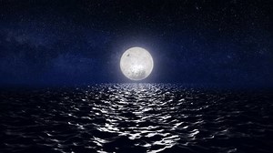 Moon over the sea with moonlight reflections on the water