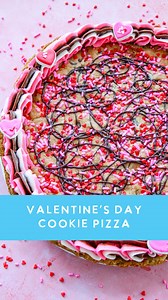 Sweetheart Swirl Cookie Cake AKA Cookie Pizza ❤️🩷 A semi-homemade cookie cake perfect for Valentine’s Day. 🍪 Comment RECIPE for a printable version with links or save/screen shot the details below. Ingredients 1 1/2 packages chocolate chip cookie dough (16 oz break-and-bake), or 24–30 oz total dough 1/4 cup Valentine’s Day sprinkles Swirl Frosting 1 cup salted butter, softened 3 1/2 cups powdered sugar 1 teaspoon vanilla extract 4–6 tablespoons heavy cream 1 tablespoon unsweetened cocoa powder