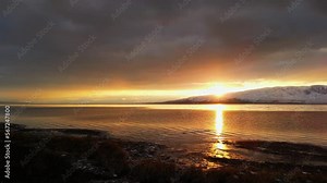 Flying over the shoreline of Utah Lake during colorful sunset reflecting in the water. Stock Video