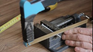 Master saw off part of the bolt with a hacksaw, close-up. Part one.