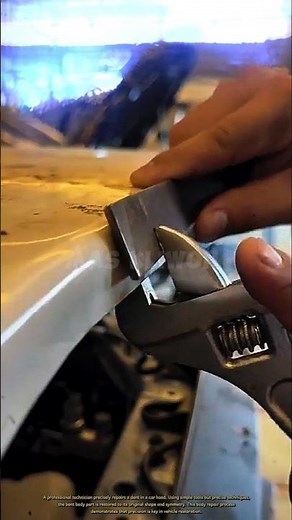 A professional technician precisely repairs a dent in a car hood.