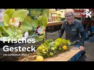 Elongated table arrangement with Cymbidium – modern & natural design