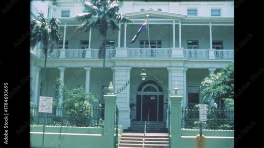 Queensland Parliament House building showcasing its historical architecture, elegant columns, and balconies with Australian flag flying, depicting an archival scene from Brisbane in 1984 in Australia