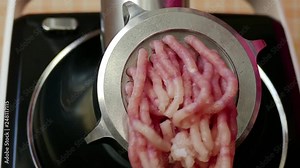 Kitchen electric meat grinder shreds meat into strips of minced meat...Unmodified camera color.