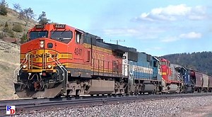 A BNSF grain train running over the Montana Rail Link with a varied set of power on the head end, rear end helpers and MRL crews at both ends nears the summit of Bozeman Pass at Muir. From the Highball Productions show "Montana Rail Link 2007" https://rfd.video/MRL2007 | Railfan Depot