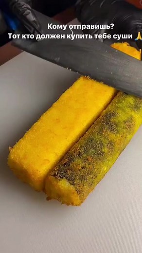 Slicing Fried Fish Sticks: A Close-Up Kitchen Tutorial