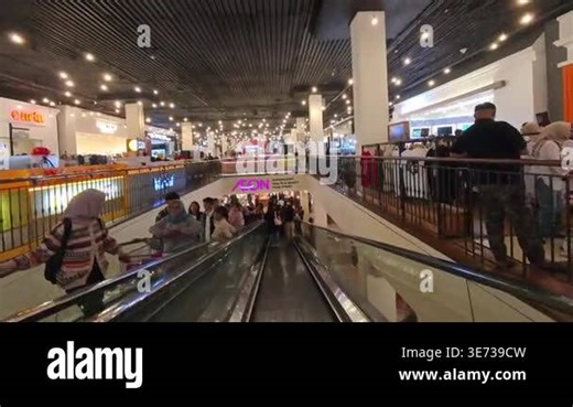 Bandung, Indonesia, April 3, 2026. First-Person Video of entering AEON Retail in Paris Van Java Mall Bandung by descending the escalator. 4K Time-lapse Footage of the crowd at the mall Stock Video Footage - Alamy