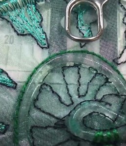 Free-motion machine embroidery techniques on transparent fabric