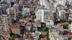 Aerial view Tirana Albania. Drone flying over houses and high-rises in the city center with streets and roads.