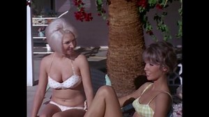 CIRCA 1967 - In this sexploitation movie, sorority sisters dance by a swimming pool.