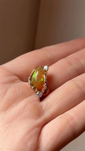 Ending October on an opal high ✨ This fiery Mexican opal shines bright in its one-of-a-kind freeform setting — twisted gold and diamond accents for that extra wow factor 🔥💎 14kt yellow gold $1000 | Bella Bijou Fine Jewelry