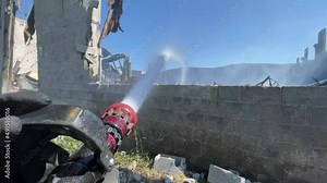 Firefighters putting out a factory fire.
