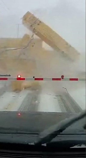 Freight Train Loses Lumber at Blizzard-Covered Railroad Crossing 🚆