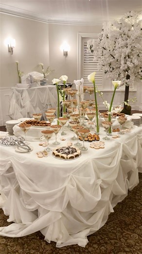 RYAN DESIGNS | Event Design, Decor & Lighting on Instagram: "One of our first weddings of the year at the stunning Ocean Cliff in Newport, and we're already so inspired by what couples are choosing for 2026. We transformed this cocktail hour with custom fabric draping and rosettes that added texture, dimension, and sophistication. We're hoping to see so much more table draping in 2026 because it truly elevates the entire atmosphere 🤍 Content by: @carolinecarletonsocials #tabledraping #weddingde