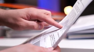 Hands Pointing at Text then Crumpling Paper