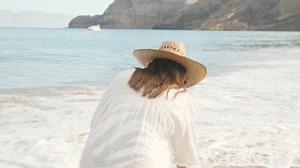 Picking up a stone from the beach - Free Stock Video Footage | Coverr