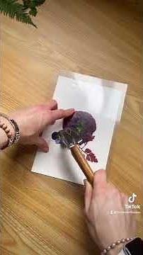 Unedited process video of hammering flowers to create a natural print on paper.