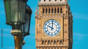 Big Ben clock tower on a sunny early morning in London, UK. A view of the popular London landmark, the clock tower known as Big Ben, showing 3pm as the time set against a blue and cloudy sky.