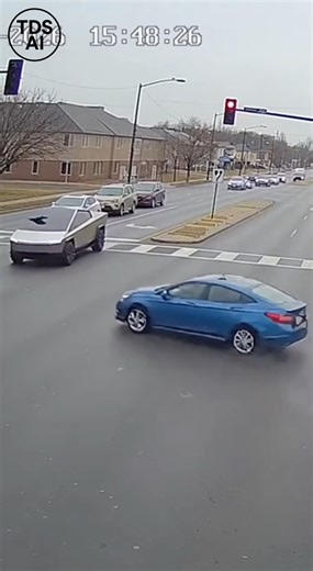 Traffic Cam Captures Red-Light Violations Leading to Collision at Busy Intersection Traffic camera footage shows multiple vehicles entering an intersection against a red light before colliding with oncoming traffic. The video documents the moments leading up to the crash as drivers proceed through the signal without stopping, resulting in a sudden impact that brought traffic to a halt. Emergency responders arrived shortly after to manage the scene and assist those involved. Officials later empha