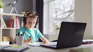 clip-1089115967-boy-doing-his-homework-table-cute-child