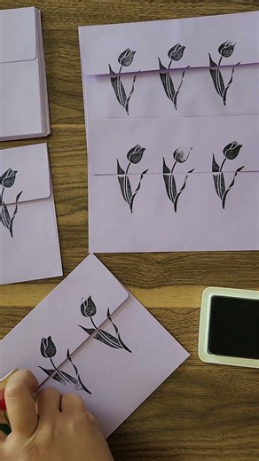 Stamping envelopes for May mail.