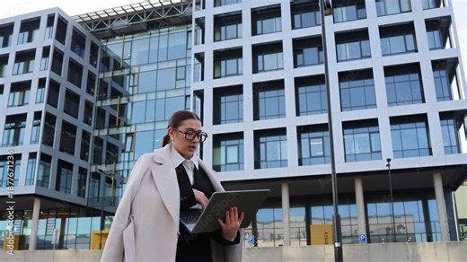 Secretary fixing work on laptop while walking outside modern glass office showing anger pressure and forced overtime after strict boss demands in busy business district