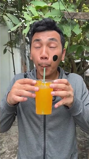 Drinking juice using a giant straw