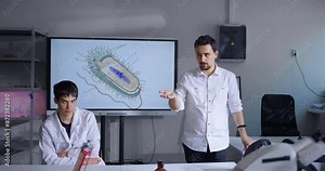 Studying Microbiology In School, Biologist Teacher Speaking In Classroom, Cell Structure On Display