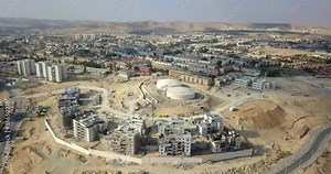 Drone footage over Dimona City and Construction Site in Negev desert, Israel
