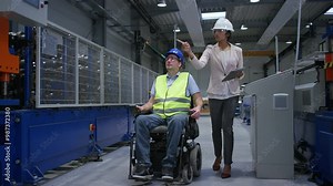 Female manager training a new employee with a disability for a job, explaining work on machines, full shot. Industry, inclusion and workplace concept. Stock Video