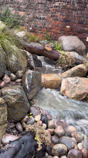 𝕋𝕠𝕞 𝕎𝕚𝕟𝕕𝕝𝕖 - 𝔾𝕒𝕣𝕕𝕖𝕟𝕤𝕔𝕒𝕡𝕖 on Instagram: "Pondless Waterfall 🌿 We build this beautiful Pondless waterfall as part of the’Let them Play’ Charity build. This is going to provide a relaxing sensory area for the children, as well as a place the kids can learn and play in the Natural Ecosystem we have created! 🌿 I love my Job. Massive Thanks to the guys at Aquascape and Landscape+ for helping to provide the goods to make this possible! 🫶🏼 #aquascape #ecosystem #pondlesswaterfall