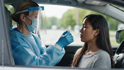 Healthcare worker administering nasal swab test