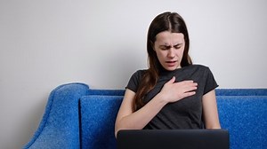 Brunette woman feel sudden pain heartburn having heart attack relieve pain after sedentary computer work at home