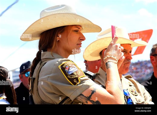 LINCOLN, AL - APRIL 26: A Talladega County Sheriff records a video of the race action during the NASCAR Cup Series Jack Link's 500 race on Sunday April 26, 2026 at the Talladega Superspedway in Lincoln, AL. (Photo by David J. Griffin/Icon Sportswire) (Icon Sportswire via AP Images Stock Photo - Alamy