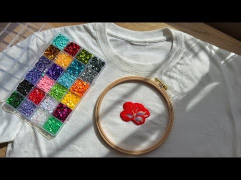 Embroidering a vibrant beaded hibiscus flower on a T shirt 🌺