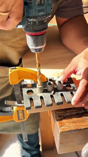 drilling precise holes into wood using an electric hand drill with a guide jig for joinery work
