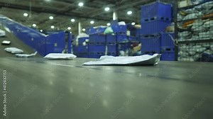 Sorting mail packages at the factory. Linear conveyor at the factory. Mail sorting. Warehouse. Close-up