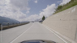 Driving a car on the Gotthard Pass from South to North Switzerland. Amazing Views of the swiss alps and the mountains from the Cars point of view. Famous Gotthardpass or Passo del San Gottardo.
