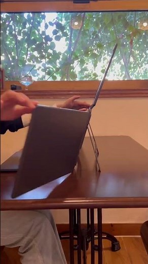 Laptop or tablet stand with multiple slots keeps devices organized stable and comfortable to use