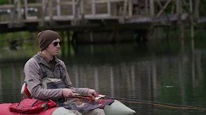 Download Fly fisherman fishing from float tube for free