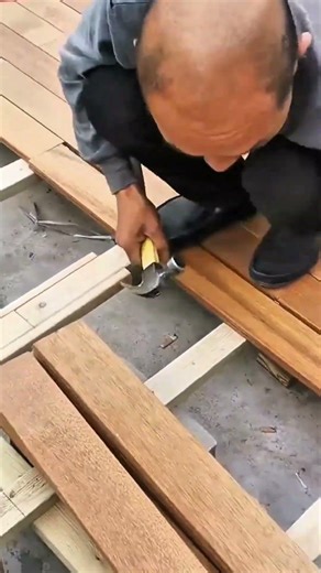 Carving circular patterns into a wooden surface using a sharp gouge for decorative craftsmanship