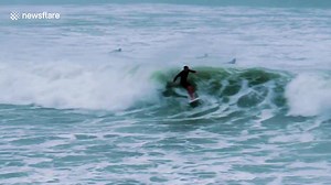Surfers ride huge waves off New Zealand as Cyclone Cook hits