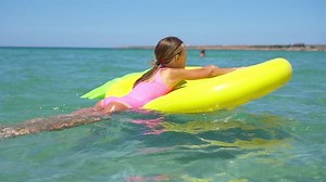 clip-1066620916-adorable-little-girl-on-inflatable-air-mattress