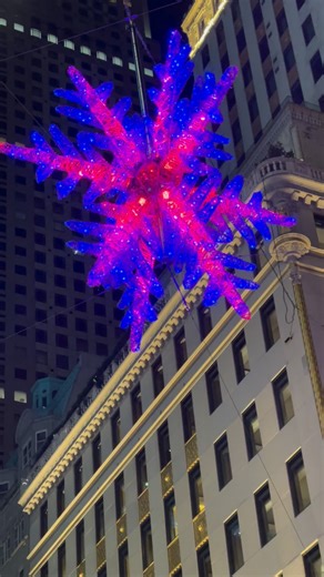 Fifth Avenue’s snowflake, a longtime NYC holiday landmark, has been refurbished and re-lit. The project, announced by the Fifth Avenue Association and the Stonbely Family Foundation, features 16,500 crystals and high-intensity full-color LED lights. The snowflake measures about 30 feet in diameter and is suspended 50 feet above Fifth Avenue at 57th Street, mounted to four buildings: the Aman Hotel, Bergdorf Goodman, Bulgari, Louis Vuitton, and Tiffany & Co. Upgrades include more than 600 new dou