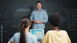 Handsome teacher clapping hands to celebrate successful project while diverse student raised arms with happiness. Instructor applause high school children to inspire to coding program Edification