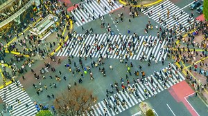 Timelapse of pedestrians crossing the street and cars at Shibuya intersection in the heart of Tokyo, Japan, Asia
