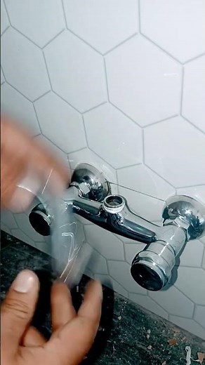 how instal #wall-mounted #kitchen sink mixer tap being installed with an adjustable wrench @umark07